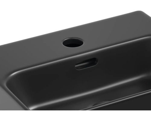 Vue détaillée d''un lavabo noir avec trou de robinet et trop-plein