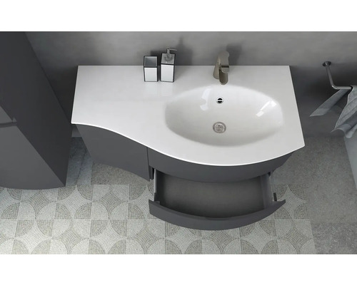 Meuble-lavabo de salle de bains avec tiroir ouvert, robinet et porte-serviettes dans une salle de bains