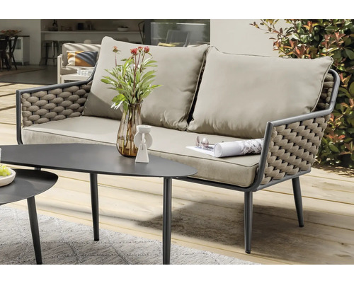 Salon de jardin avec canapé et table sur une terrasse