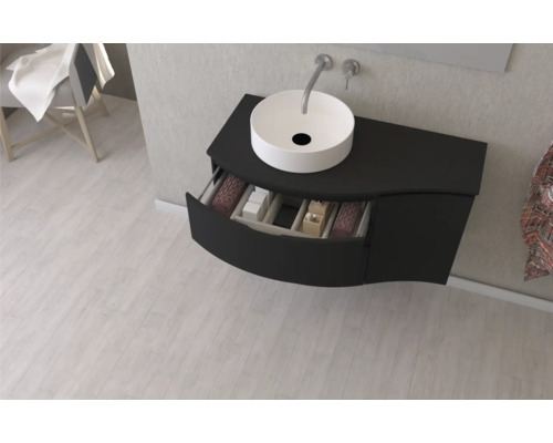 Meuble-lavabo avec tiroir ouvert et vasque à poser dans la salle de bains.