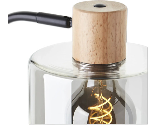 Gros plan d''une lampe de table avec pied en bois et corps en verre