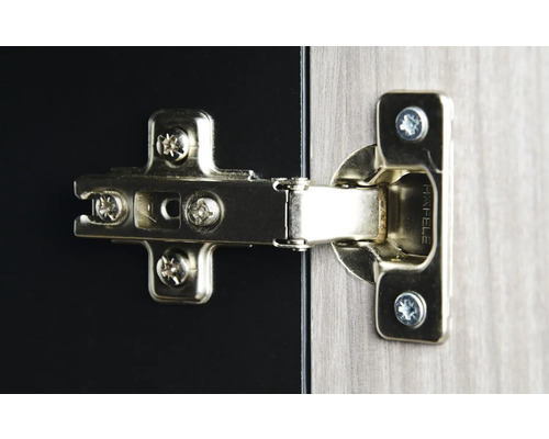 Charnière de meuble fixée à une porte de meuble avec des vis