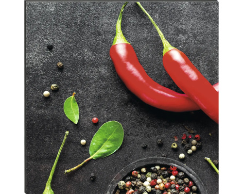 Deux piments rouges avec grains de poivre et feuilles