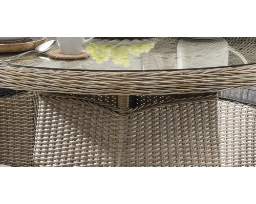 Vue détaillée d''une table de jardin avec plateau en verre et structure en rotin
