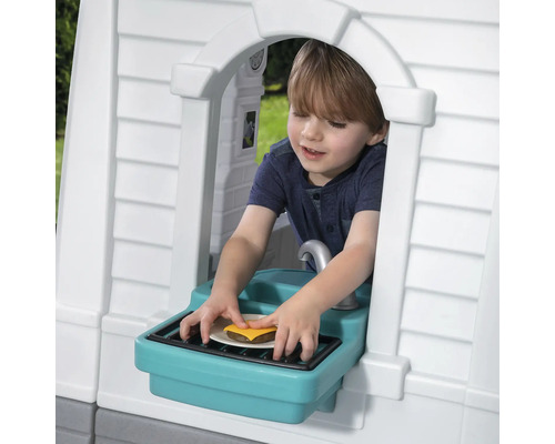 Garçon jouant avec un burger dans une cabane