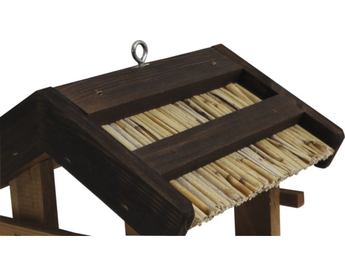 Vue détaillée d''un nichoir avec toit de chaume et dispositif de suspension