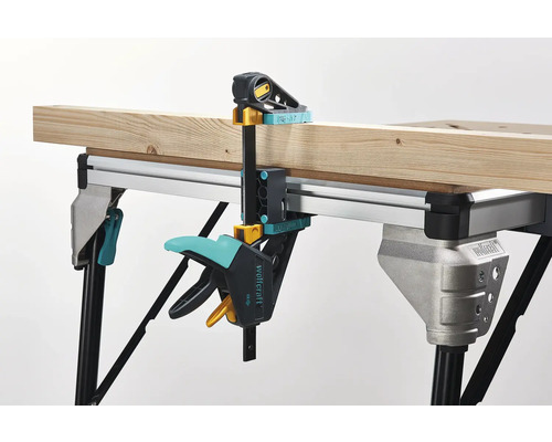 Werkbank mit Holzstück, fixiert mit einer Schraubzwinge von Wolfcraft
