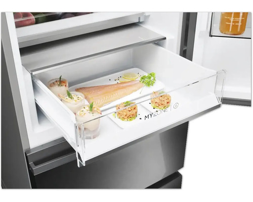 Réfrigérateur avec tiroir ouvert, rempli de nourriture