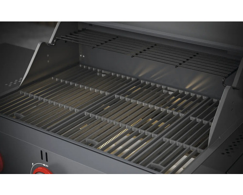 Vue intérieure d''un barbecue à gaz avec grille de cuisson et grille de maintien au chaud.