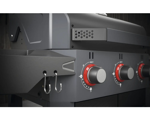 Vue détaillée d''un gril à gaz avec boutons rotatifs et crochets