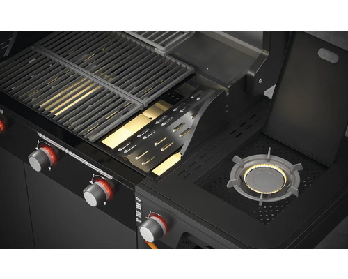 Vue détaillée d''un barbecue à gaz avec grille et brûleur latéral