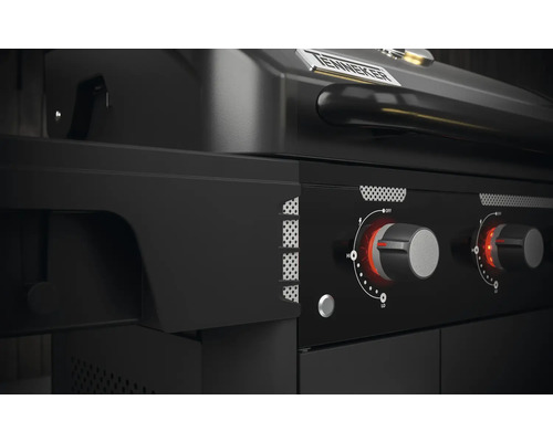 Gros plan d''un barbecue à gaz noir avec des boutons rotatifs pour régler la chaleur