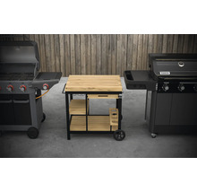 Deux barbecues à gaz flanquent une table de barbecue avec tiroir et étagères.