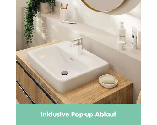 Lavabo dans salle de bains avec robinet, savon et articles de toilette