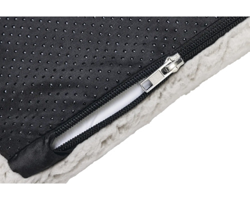 Détail de la fermeture éclair d''un lit pour chien avec fond antidérapant