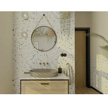 Salle de bain lumineuse avec meuble-lavabo, miroir rond et papier peint terrazzo