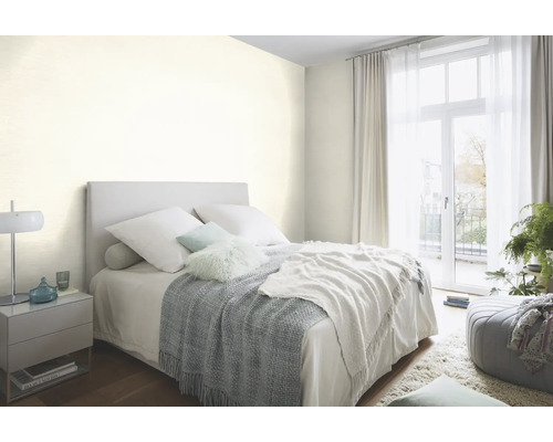 Chambre lumineuse avec lit, table de chevet et couvre-lit