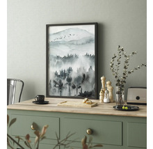 Tableau encadré avec motif aquarelle d''un paysage de montagne sur une table