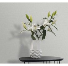 Vase mit Lilien auf einem Tisch