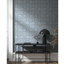 Vue d''une pièce avec papier peint à motifs, console, livres et décoration