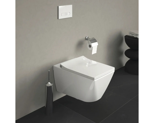 WC suspendu avec plaque de commande et support de papier toilette dans une salle de bain