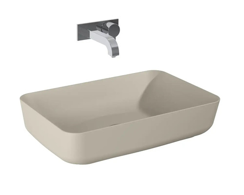 Vasque à poser beige avec robinet mural chromé