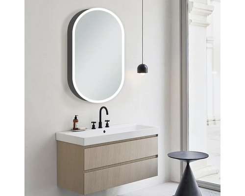Salle de bains moderne avec meuble sous-lavabo, miroir ovale avec éclairage et lampe
