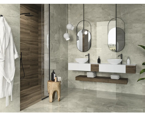 Salle de bains lumineuse avec douche, double vasque, miroirs suspendus et carreaux gris.