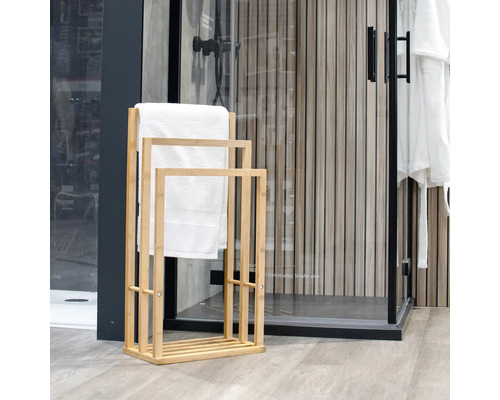 Badezimmerszene mit Handtuchständer aus Holz und weißen Handtüchern