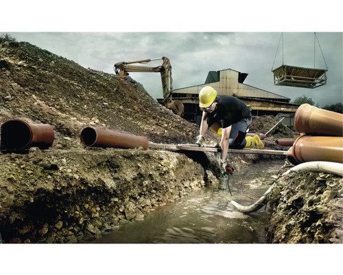 Baustellenszene mit Bauarbeiter, Bagger und Rohren bei Grabungsarbeiten