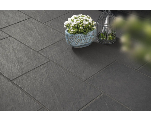 Verlegte dunkle Terrassenplatten mit Dekoration.