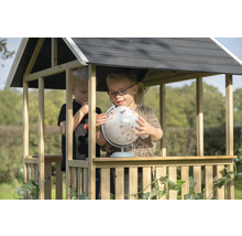 Deux enfants jouent avec un globe dans une cabane en bois dans le jardin.