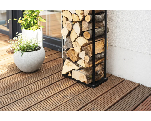 Étagère à bois de chauffage en métal avec bois de chauffage sur une terrasse en bois