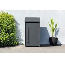 Boîte aux lettres à colis indépendante à côté d''une plante et d''un buisson