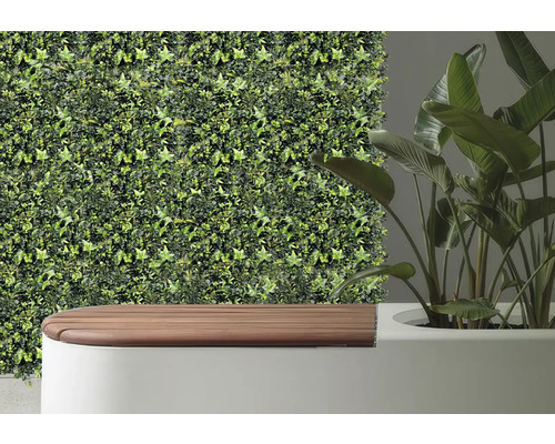 Dekorative Wandverkleidung mit künstlichem Efeu neben einer Bank und einer Zimmerpflanze.