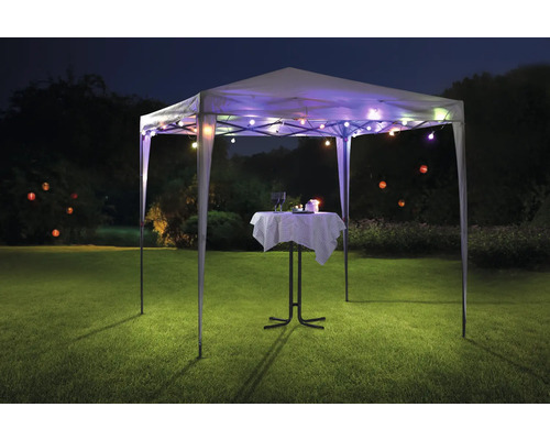 Pavillon mit Lichterkette und Bistrotisch auf einer Wiese