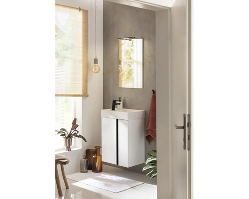 Salle de bain lumineuse avec meuble sous-vasque, miroir et décoration