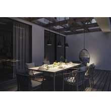 Terrasse avec table à manger, chaises et suspensions sous une pergola