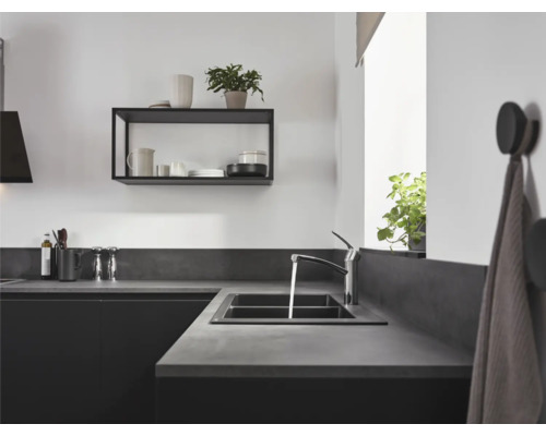 Moderne Küche mit Spüle, Armatur, Ablage und Küchenutensilien.