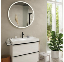 Salle de bain avec lavabo, miroir rond avec éclairage et plante d''intérieur