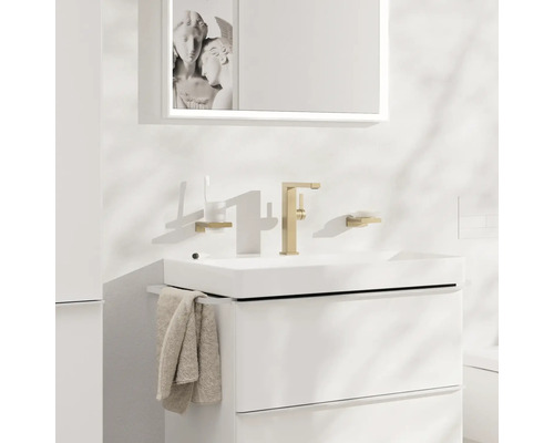 Modernes Badezimmer mit weißem Waschtischunterschrank, goldener Armatur und Spiegel