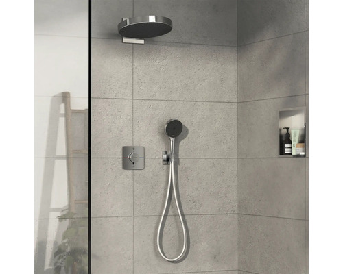 Robinet de douche avec pomme de tête et douchette à main dans une cabine de douche moderne.