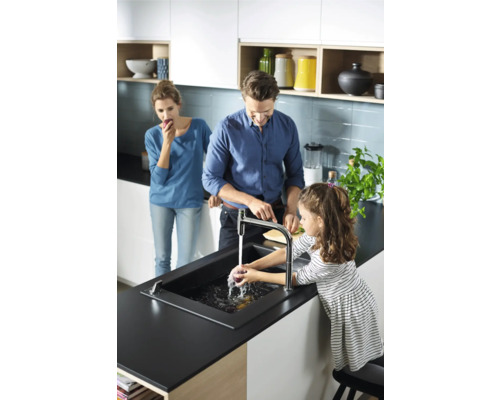 Famille dans une cuisine lumineuse avec évier et robinet lavant des légumes