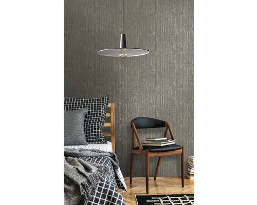 Szene mit Bett, Stuhl, Lampe und einer strukturierten Tapete
