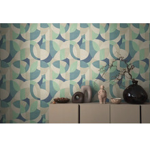 Mur avec motif de papier peint géométrique et commode avec décorations