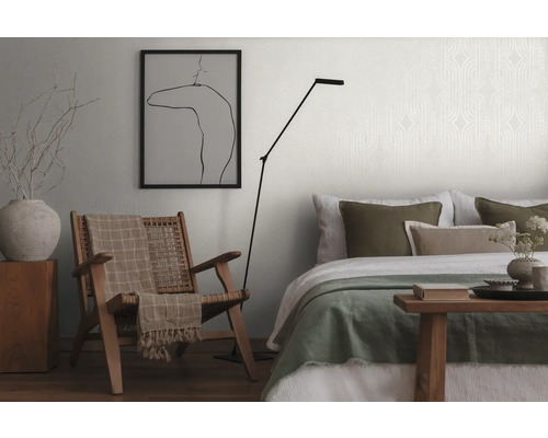 Wohnzimmer mit Sessel, Stehlampe und Bett
