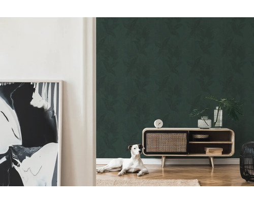 Wohnzimmer mit gemusterter Tapete und Holzkommode