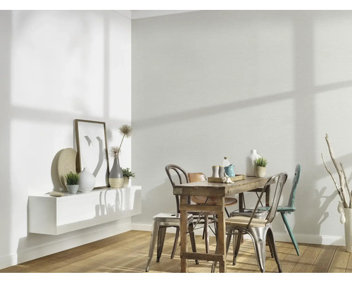 Helles Esszimmer mit Holztisch, Stühlen und weißem Wandregal mit Dekoration