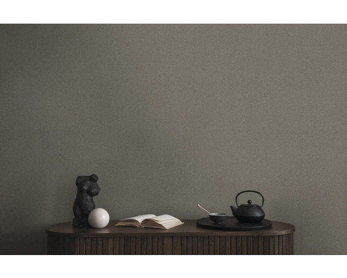 Papier peint dans un espace de vie avec table, sculpture, livre et service à thé