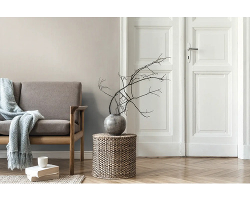 Wohnzimmer mit Sofa, Beistelltisch mit Dekoration und Holzboden.